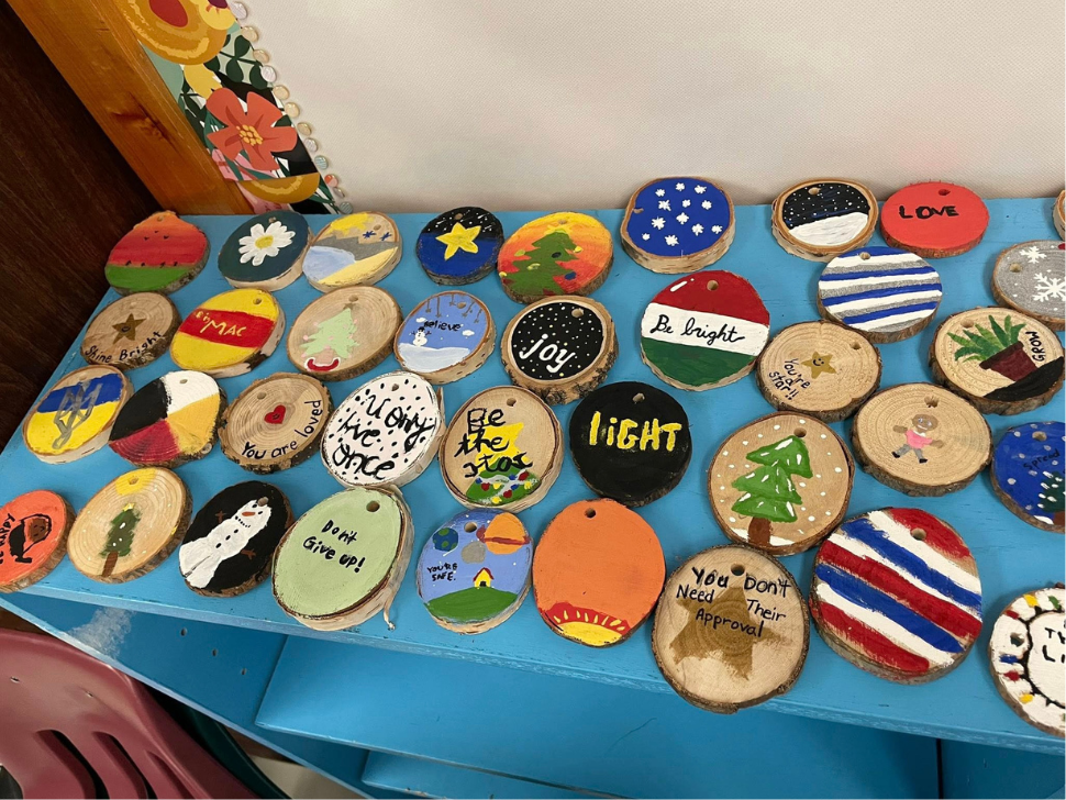 St. James kids hang handmade ornaments along Sturgeon Creek